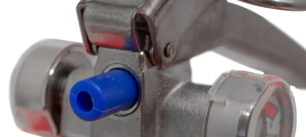 Close-up of the handle, safety pin and pressure gauges on a Britannia P50 powder extinguisher