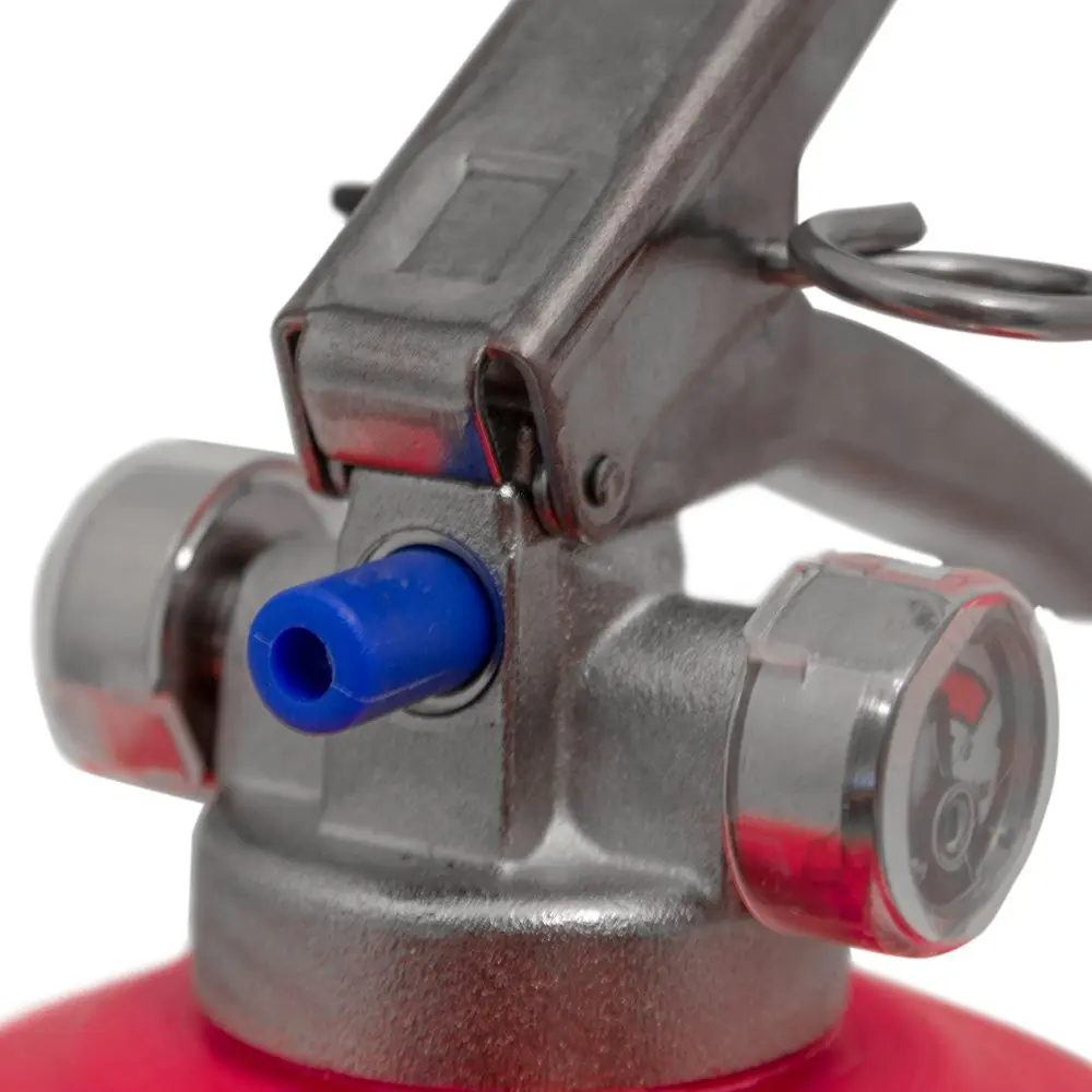 Close-up of the handle, safety pin and pressure gauges on a Britannia P50 powder extinguisher